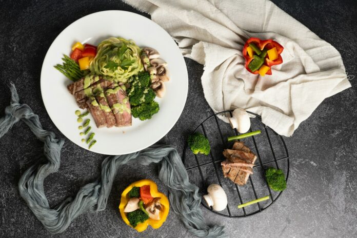 Photo by Abdelrahman Sarayreh a white plate topped with meat and veggies
